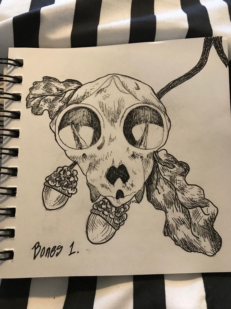 A picture of a squirrel skull with some acorns and oak leaves behind it